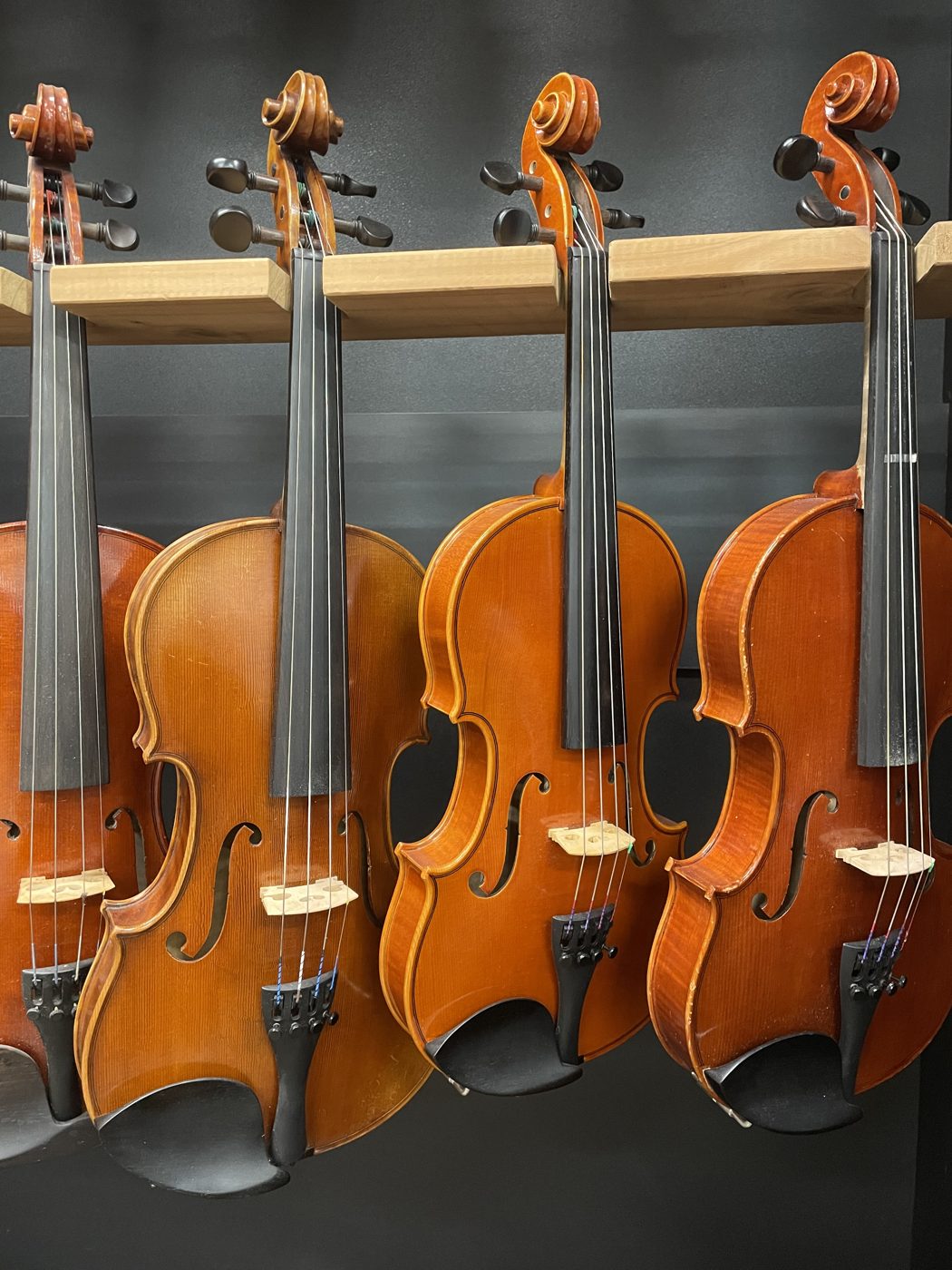 Instruments hanging in rows on the showroom wall.